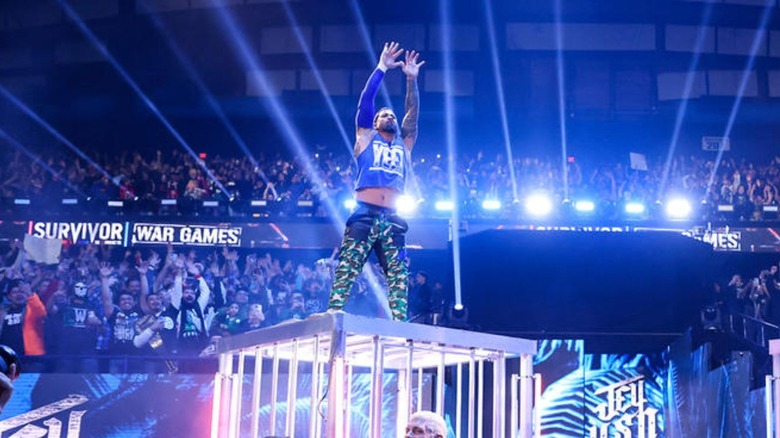 Jey Uso stands ontop of the WarGames cage at WWE Survivor Series.