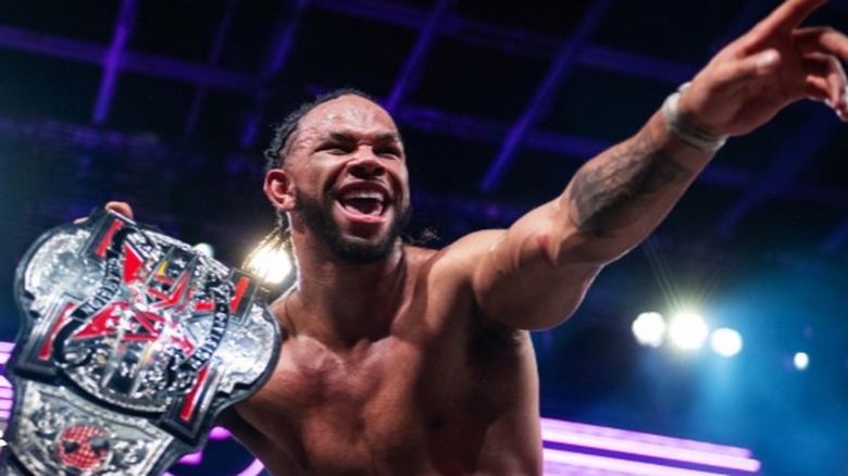 TNA X-Division Champion Leon Slater proudly holds his title up before a scheduled title defense