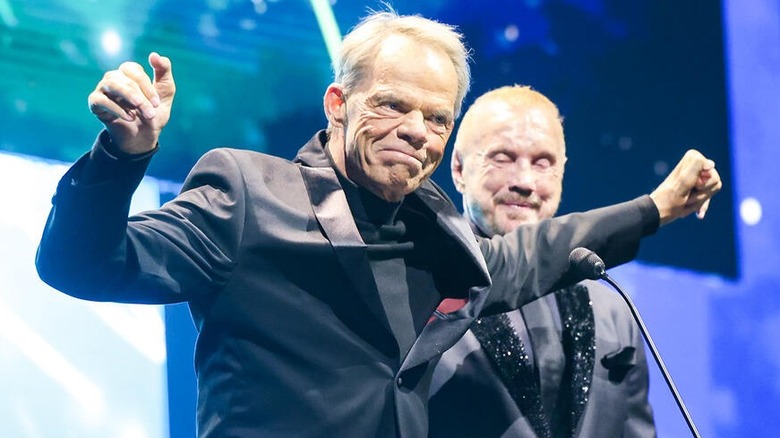 Lex Luger proudly stands tall at the podium with Diamond Dallas Page by his side at Luger's 2025 WWE Hall of Fame Ceremony
