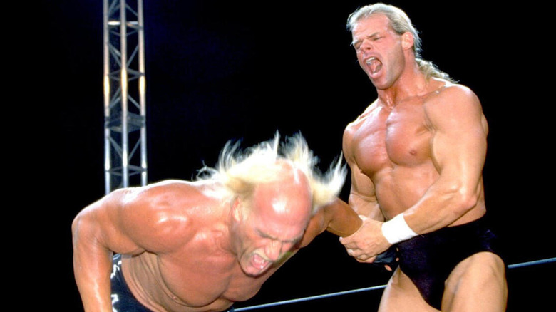 Lex Luger works a hold on Hulk Hogan