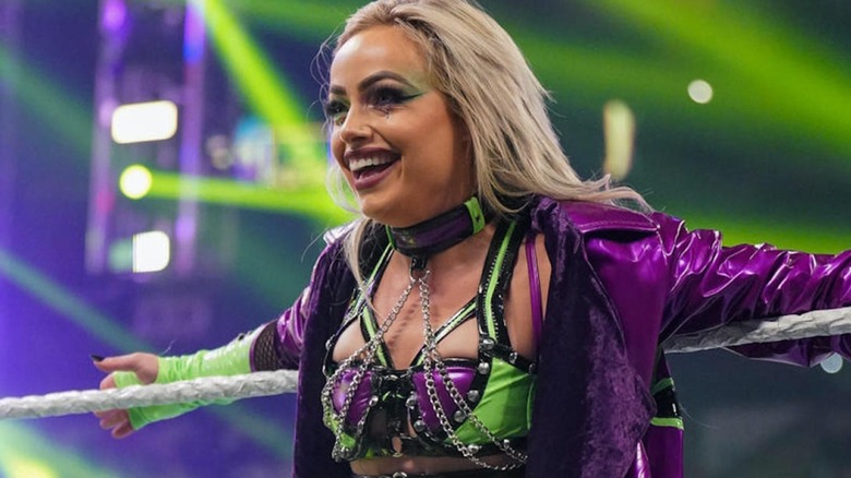 Liv Morgan leans against the ropes smiling