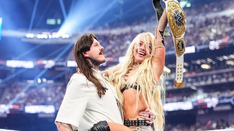 Dominik Mysterio holds up WWE Women's World Champion Liv Morgan after she won the belt from Stephanie Vaquer at WWE WrestleMania 42.
