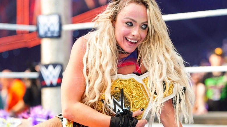 Liv Morgan holds on to the Women's World Championship in the ring after a victory at WWE SummerSlam 2026.