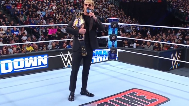 United States Champion Logan Paul stands in the middle of the ring of "WWE SmackDown" with a new PRIME logo displayed.