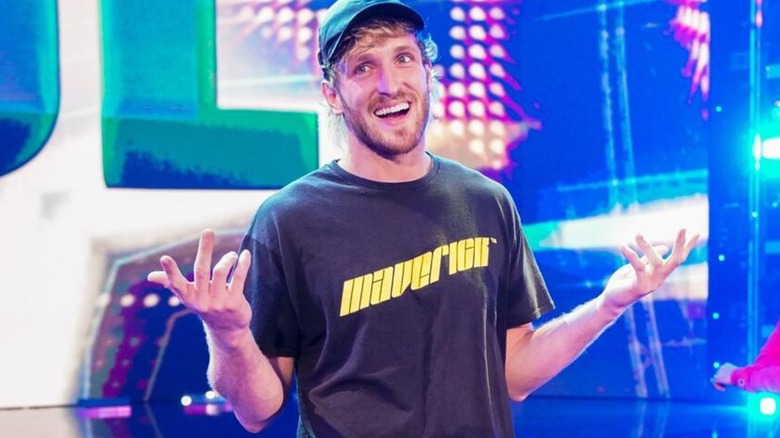 Logan Paul shrugs on the stage and looks to the fans during an episode of WWE programming.