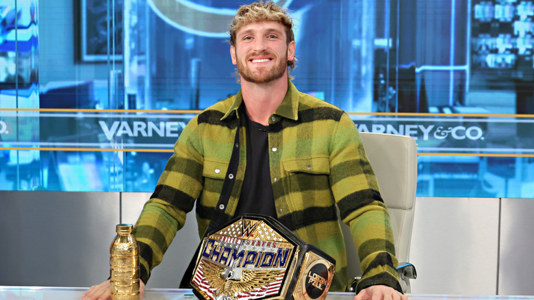 Logan Paul with the US Title and a gold bottle