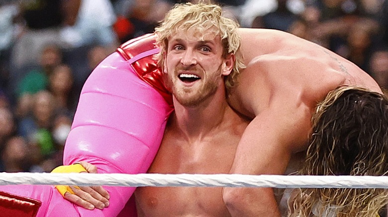 Logan Paul carrying Seth Rollins