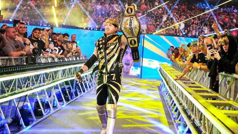 Logan Paul carries his United States Championship down the ramp for a match at a WWE premium live event.