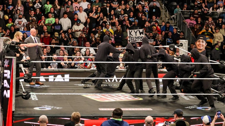 Masked man and Logan Paul on WWE Raw