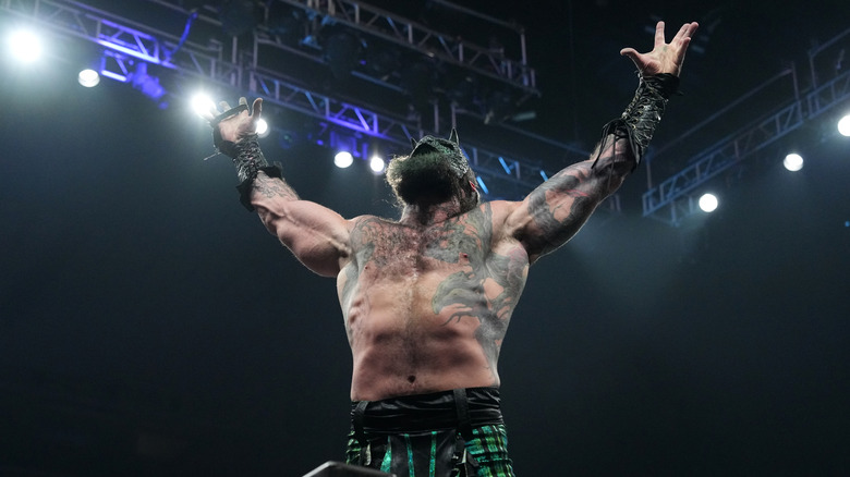 Luchasaurus poses on the ropes before a match on 