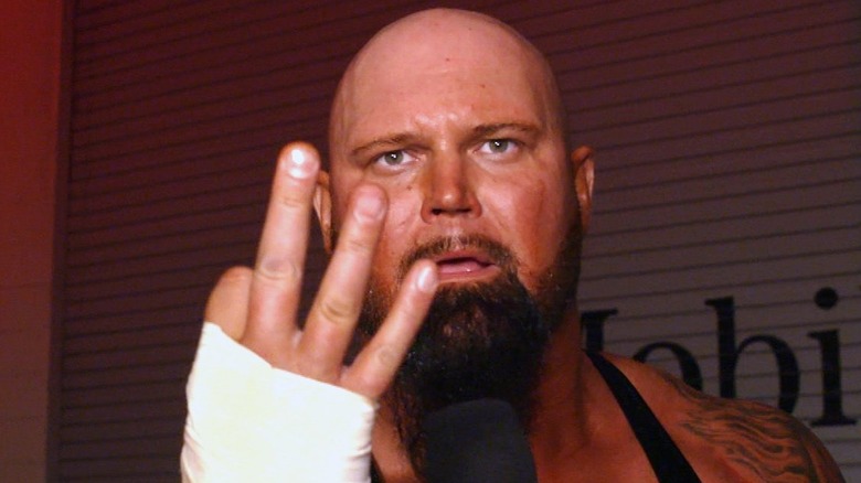 Luke Gallows holding up three fingers on WWE TV