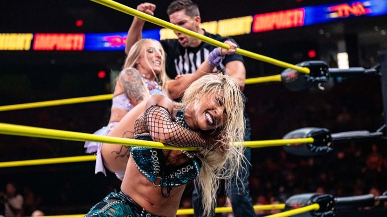Heather by Elegance has Mara Sade pinned up against the ropes during their quarterfinal match
