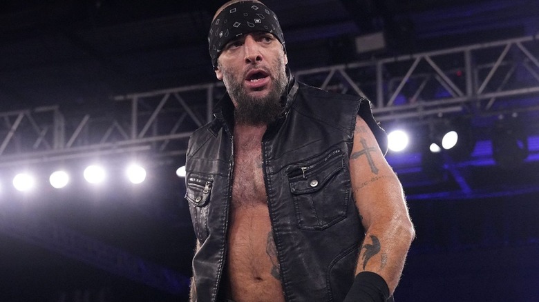 Mark Briscoe appears in a sleeveless black vest and a black headband.