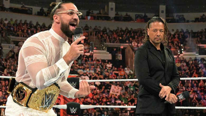 Shinsuka Nakamura looking at Seth "Freakin" Rollins in a WWE ring