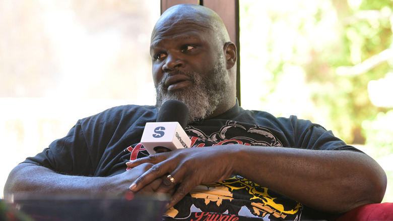 Mark Henry speaking into a SiriusXM mic