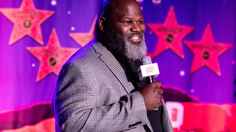 Mark Henry holding a microphone
