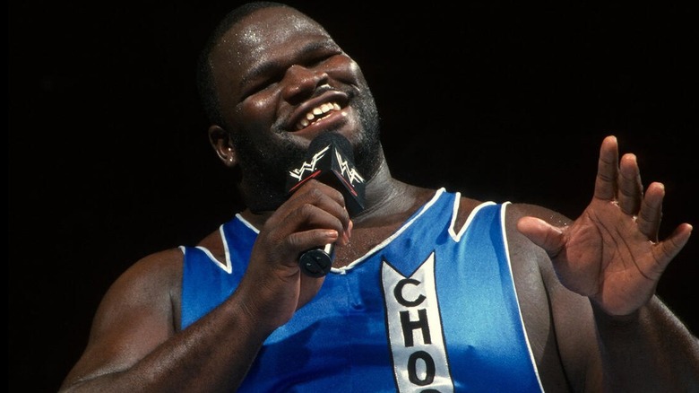 Mark Henry smiles while cutting a promo.