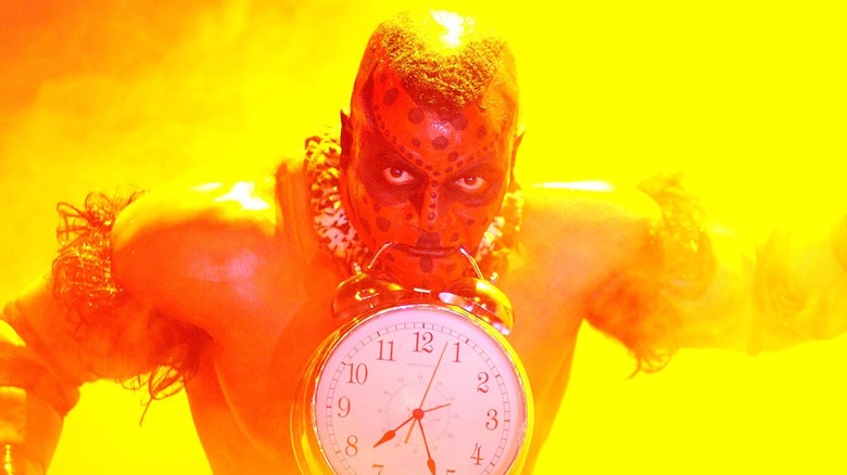 The Boogeyman in WWE with a clock hanging from his mouth
