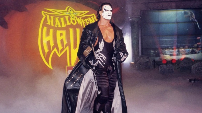 Sting in costume in front of a WCW Halloween Havoc pumpkin set