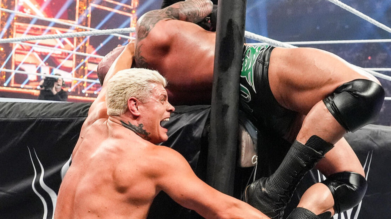 Cody Rhodes wrapping Randy Orton around the ring post