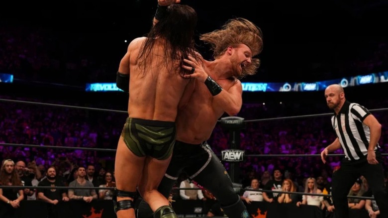 "Hangman" Adam Page delivers a Buckshot Lariat to Adam Cole in the ring during their match for the AEW World Championship at Revolution 2022.