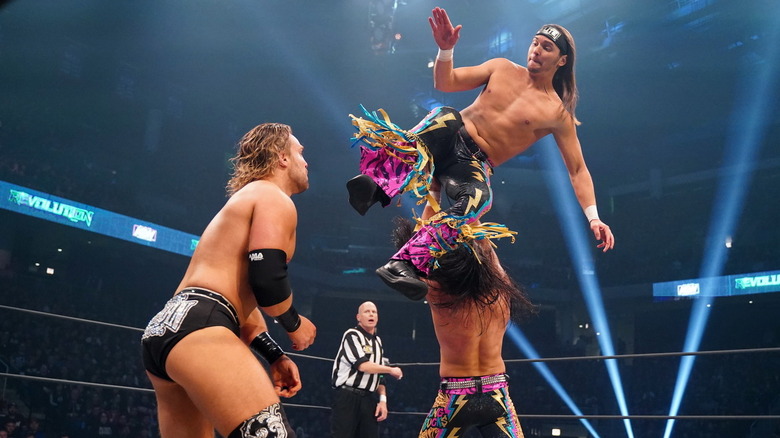 Nick Jackson about to hit Hangman Adam Page with a drop kick