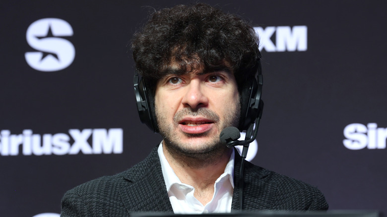 Tony Khan on headset and away from a wrestling ring