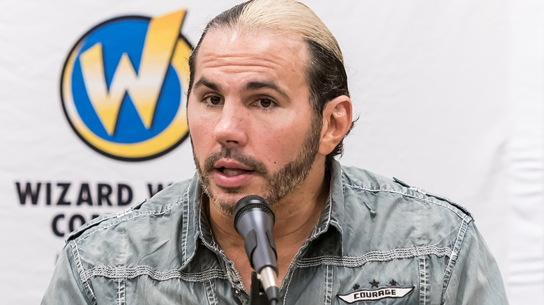 Matt Hardy sitting in front of a microphone