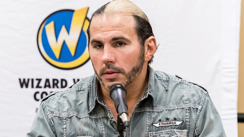 Matt Hardy sitting in front of a microphone