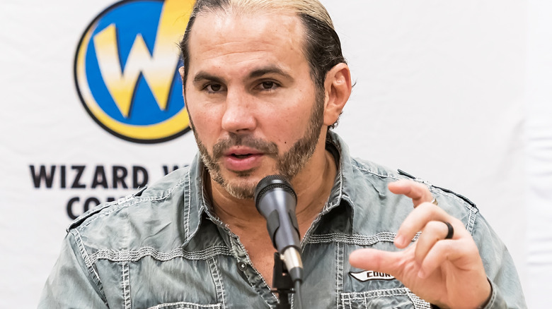 Matt Hardy sitting in front of a microphone