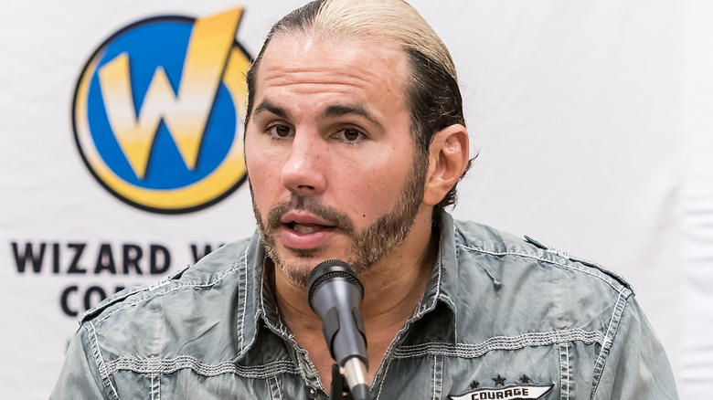 Matt Hardy sitting in front of a microphone