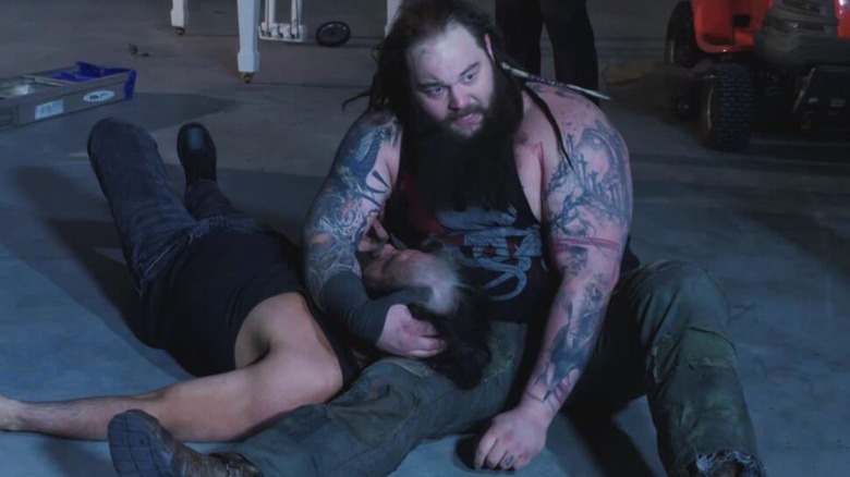 Bray Wyatt cradles Matt Hardy on the floor of a shed during their Ultimate Deletion Match on the Hardy Compound.