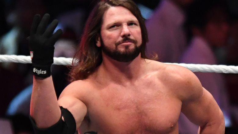 AJ Styles is holding up one hand