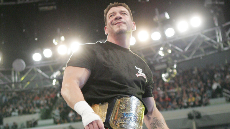 Eddie Guerrero with a title around his waist