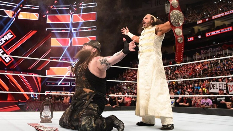The Deleters of Worlds (Bray Wyatt and "Woken" Matt Hardy) pose with the WWE Raw Tag Team Titles in the ring