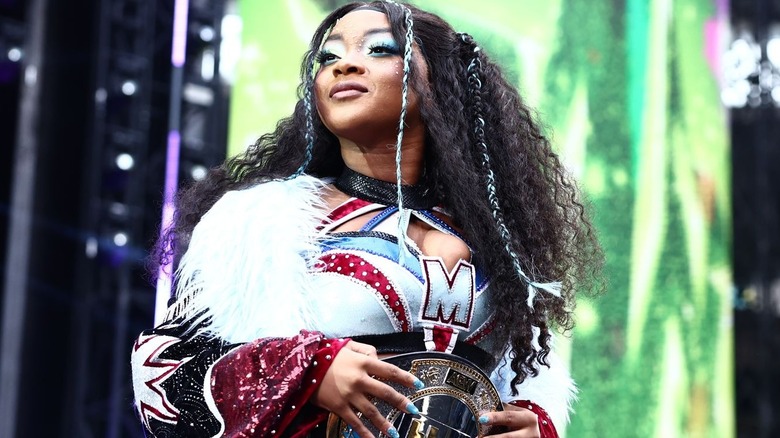 Maya World wearing the TBS Championship around her waist