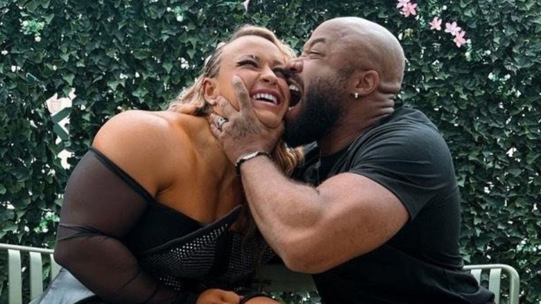 Jonathon Gresham bites the face of his wife, Jordynne Grace, as they pose for the camera in a photo posted to his X account.