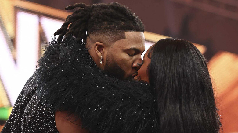 Trick Williams plants a kiss on real-life girlfriend Lash Legend in the ring on an episode of "WWE NXT."