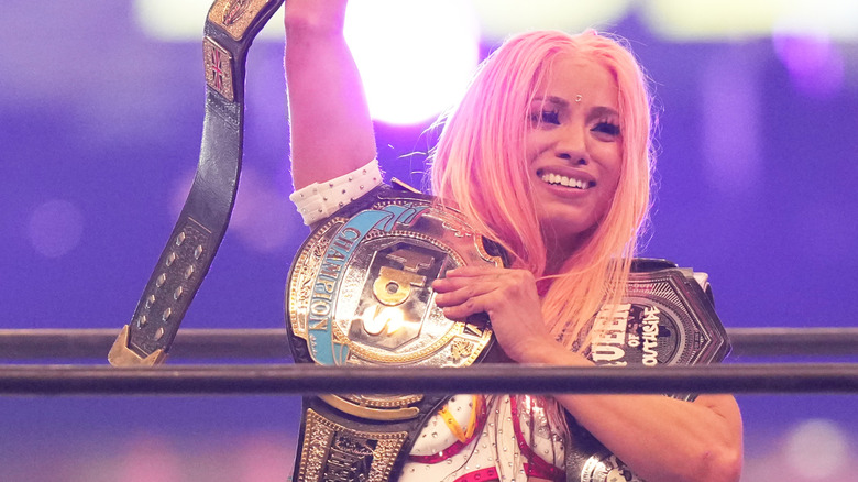 Mercedes Mone poses with title belts