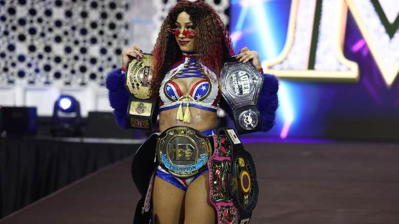 Mercedes Mone makes her entrance dripped out in several wrestling titles.