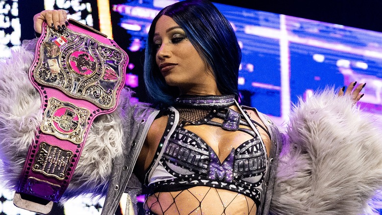 Mercedes Mone posing with the Women's Owen Hart Cup belt ahead of a match against Zayda Steel on 