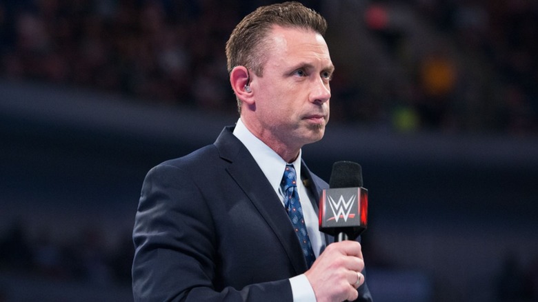 WWE commentator Michael Cole readies himself for a segment in the ring during an episode of 