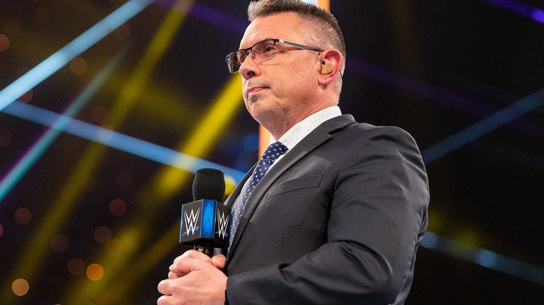 Michael Cole preparing to speak