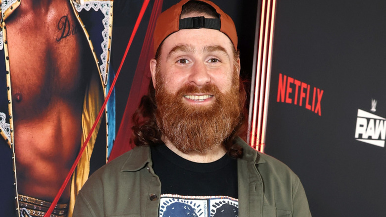 Sami Zayn wearing a backwards hat