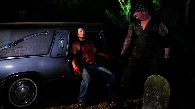 The Undertaker and AJ Styles moments before the 'Deadman' put his hand through the glass window of the hearse.
