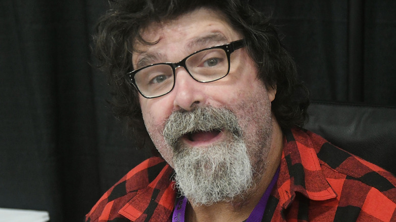 Mick foley smiling at autograph signing