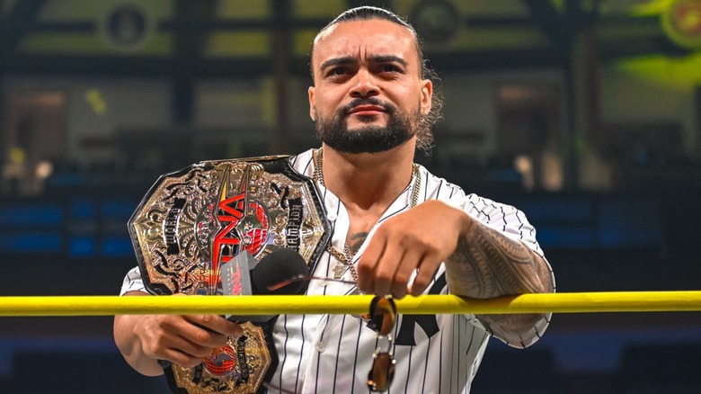 Mike Santana poses with the TNA World Championship in the ring
