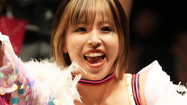 Mina Shirakawa smiling during her entrance at a STARDOM show