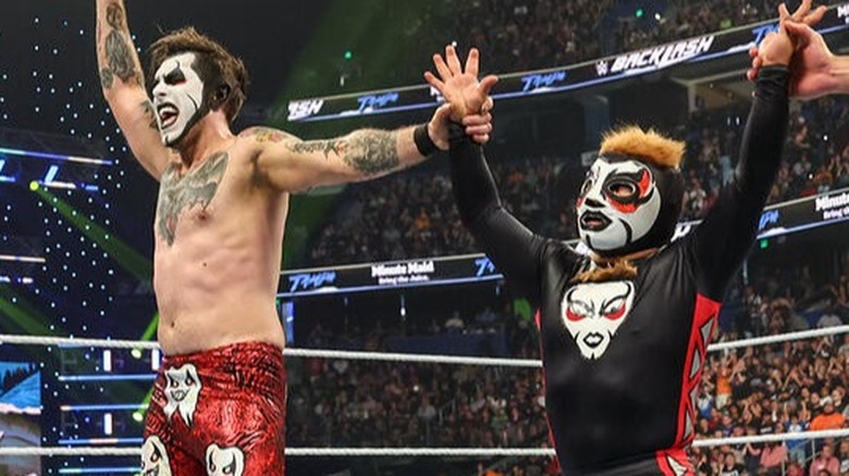Danhausen and his Minihausen celebrate their tag team victory by having their hands raised at Backlash