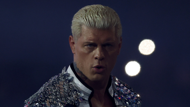 Cody Rhodes standing next to two white dots